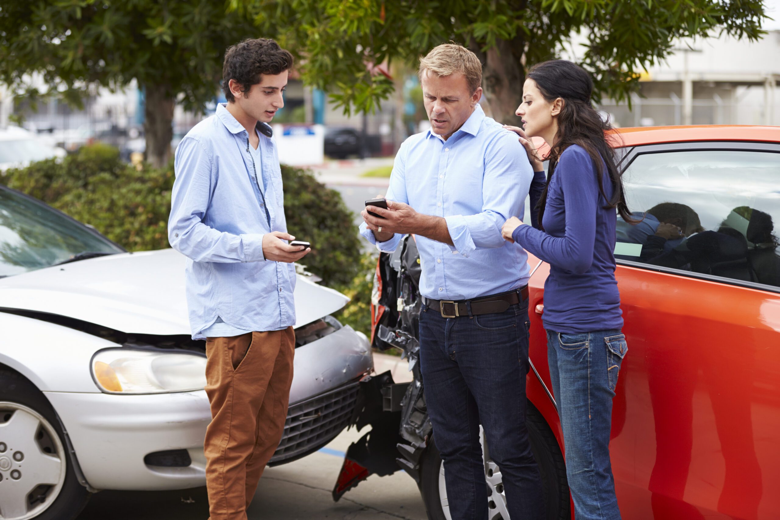 People exchanging insurance information after a car accident - advice from a car accident lawyer when there's no police report